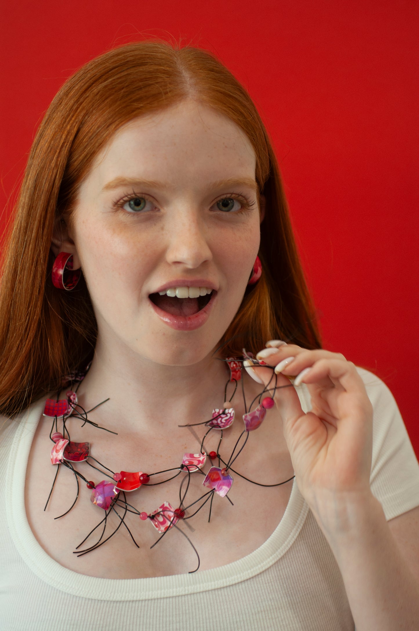 colora red necklace by irit luvaton on a red background