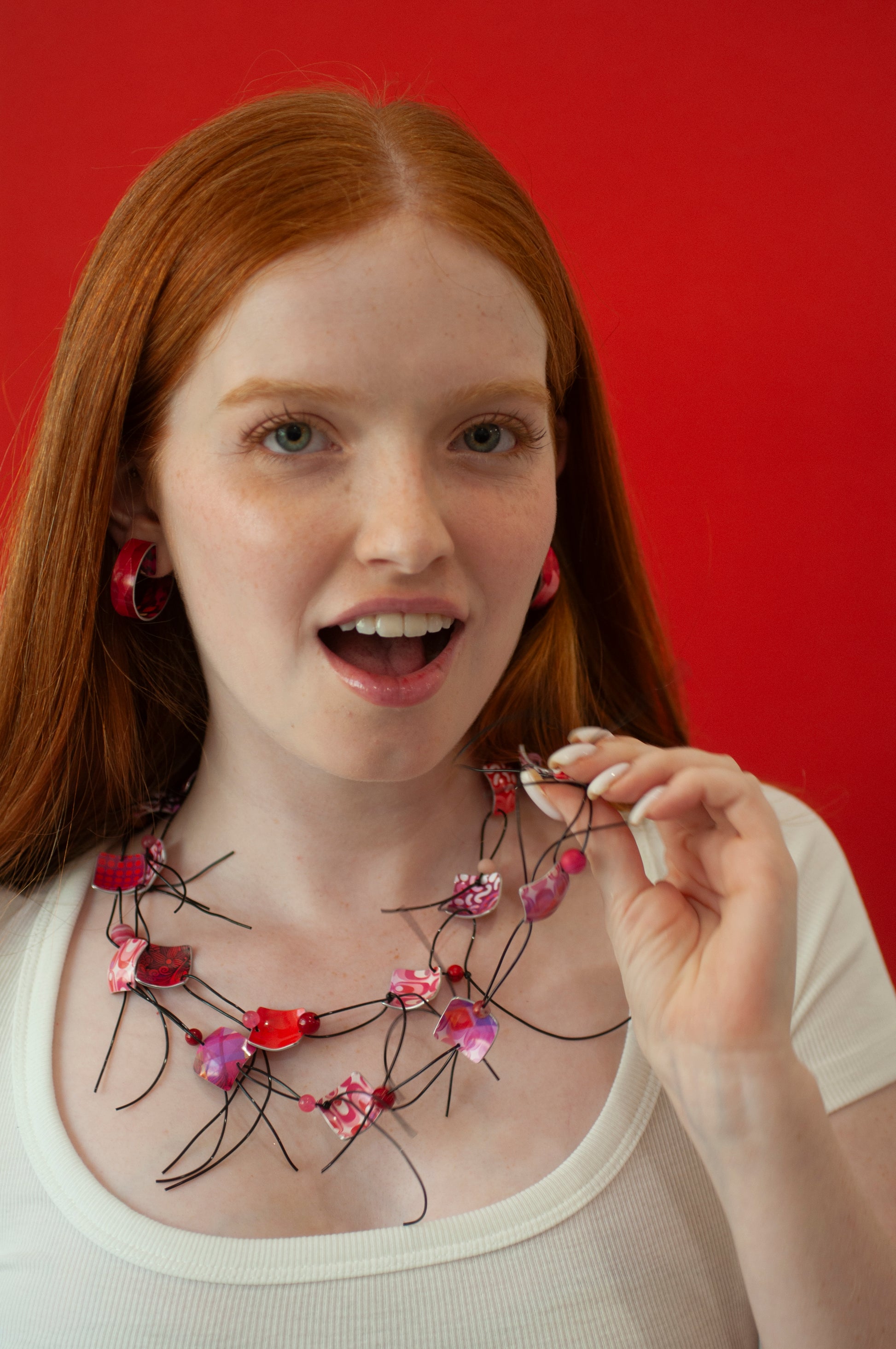 colora red necklace by irit luvaton on a red background